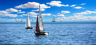 Sailboats Racing on Blue Ocean Under Cloudy Sky