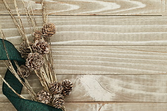 Rustic Christmas Pine Cones and Ribbon on Wood