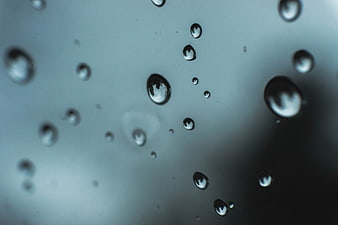 Macro shot of water droplets on a glass window surface