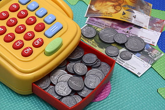Toy cash register with play money and coins