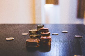 Stacks of Euro Coins on Dark Wooden Table