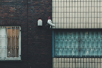 Urban Security Camera on Brick and Tile Wall