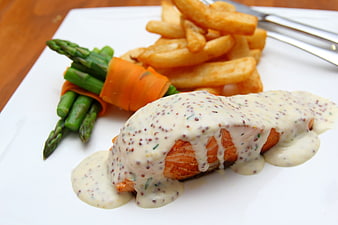 Pan-seared salmon with mustard sauce, asparagus, and fries