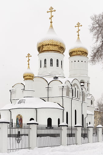 White Orthodox Church with Golden Domes in Snow