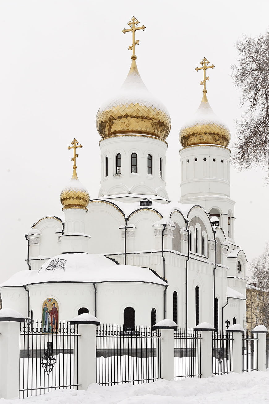 White Orthodox Church with Golden Domes in Snow