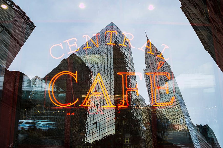 Central Cafe Neon Sign Reflected in City Window