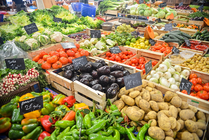 Colorful Fresh Vegetables Displayed In Wooden Crates At Local Market