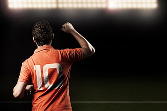 Soccer player celebrating victory on stadium field