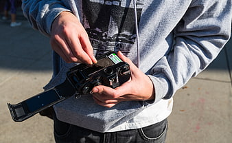 Hands Loading 35mm Film into Vintage Analog Camera