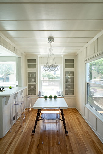 Bright White Dining Room with Hardwood Floors and Modern Furniture