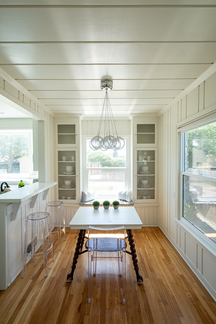Bright White Dining Room with Hardwood Floors and Modern Furniture
