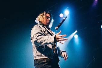 Male Singer Performing on Stage with Microphone