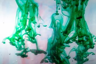 Abstract Green Ink Drops Swirling in Water