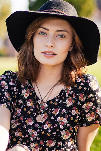 Portrait of Young Woman in Floral Dress and Black Hat