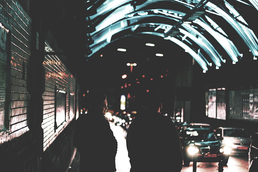 Couple Walking Under Neon Lights at Night