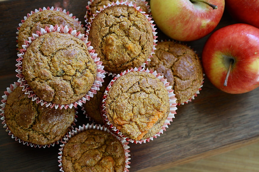 Homemade Apple Muffins with Fresh Apples on Wooden Board