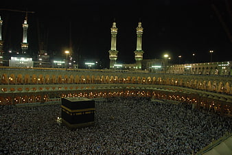 Night view of Kaaba in Mecca with massive crowd of pilgrims