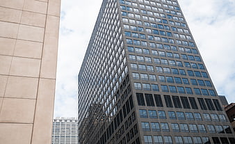 Low angle view of modern glass office building facade