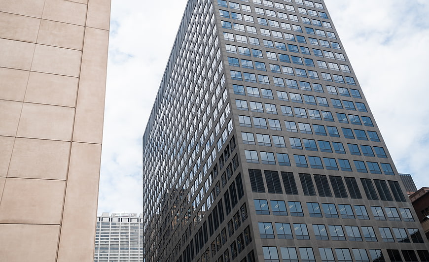 Low angle view of modern glass office building facade