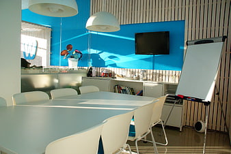 Modern office meeting room with blue wall and white furniture