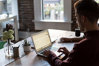 Man working on laptop in modern office workspace