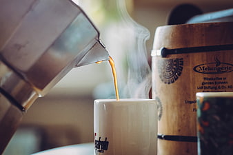 Hot Coffee Pouring from Moka Pot into White Mug