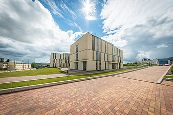 Modern University Building with Paved Plaza and Blue Sky
