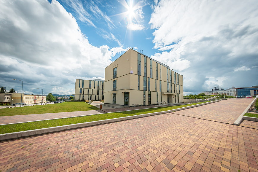 Modern University Building with Paved Plaza and Blue Sky