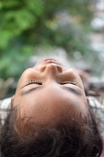 Close-up portrait of smiling child looking up outdoors