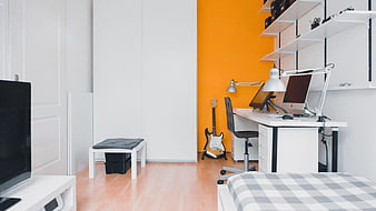 Modern Home Office with Orange Accent Wall and Electric Guitar