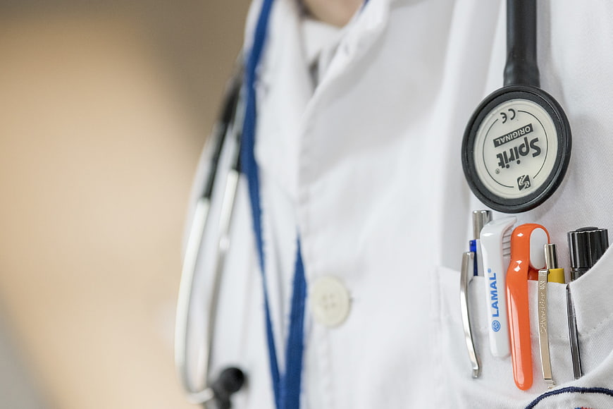 Close-up of Doctor's White Coat with Stethoscope and Medical Tools