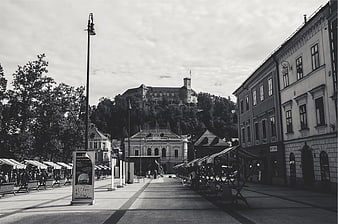 Black and white city square with castle on hill