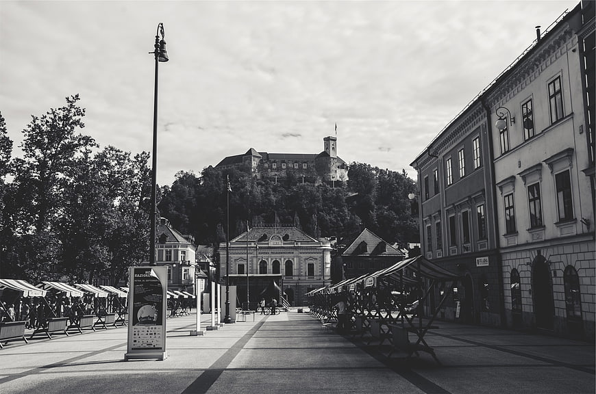 Black and white city square with castle on hill
