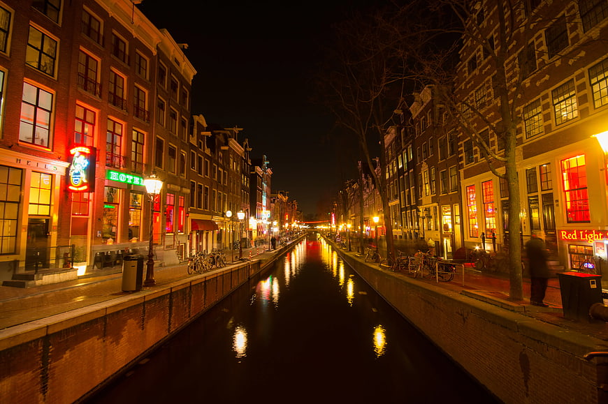 Amsterdam Canal at Night with Red Neon Lights