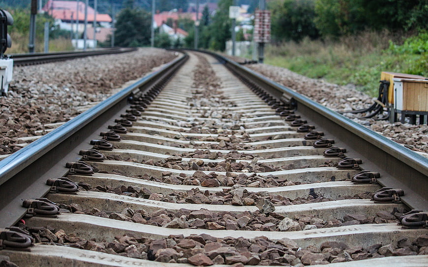 Low angle view of curving railway tracks with concrete sleepers