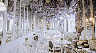 Elegant restaurant interior with hanging wisteria flowers and mirrors