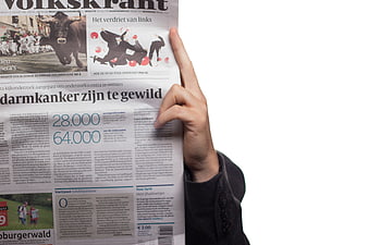 Hand holding open Dutch newspaper Volkskrant with health article