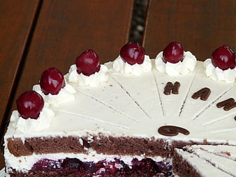 Black Forest Cake Slices With Cherries And Cream On Wooden Table