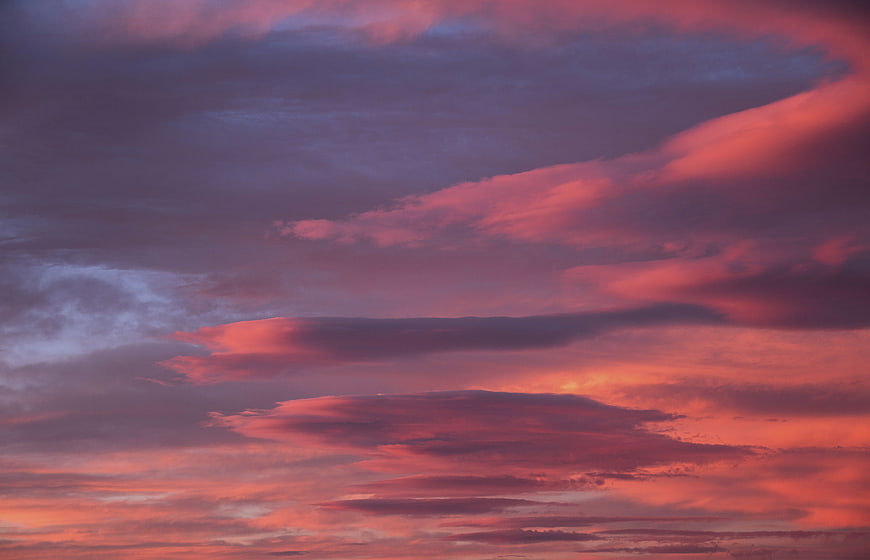 Dramatic pink and purple sunset clouds in the sky