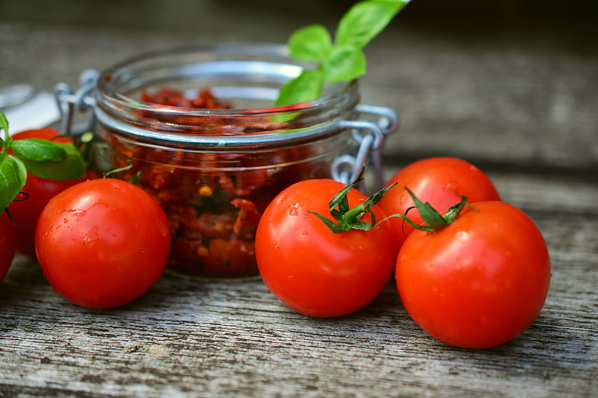 Fresh Tomatoes and Basil with Glass Jar of Sauce