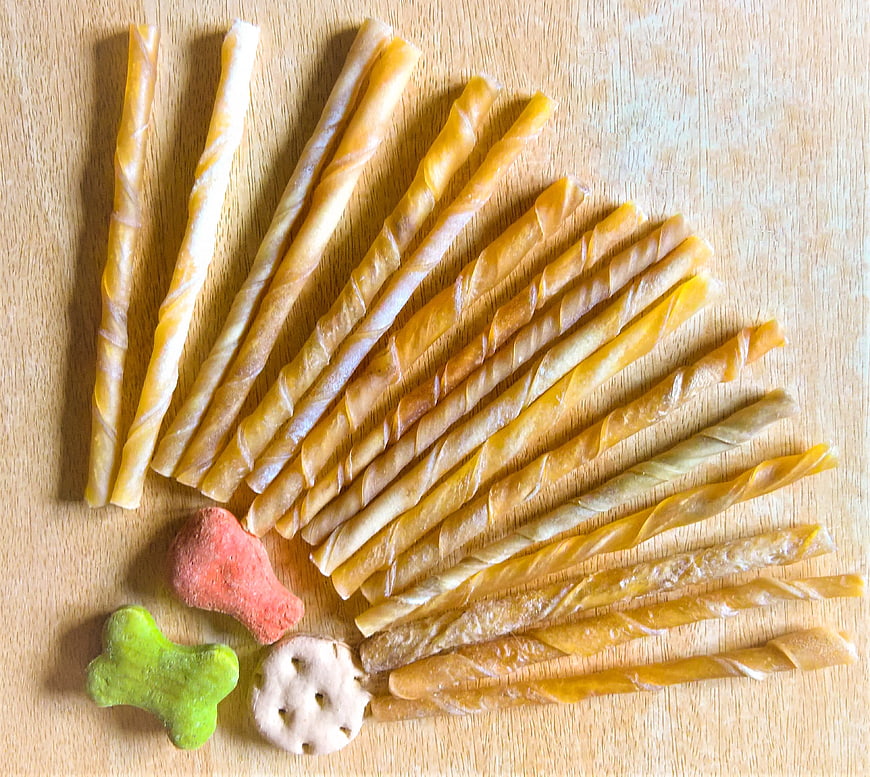Assorted Dried Dog Treats and Biscuits on Wooden Surface