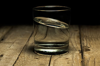 Glass of water on rustic wooden table
