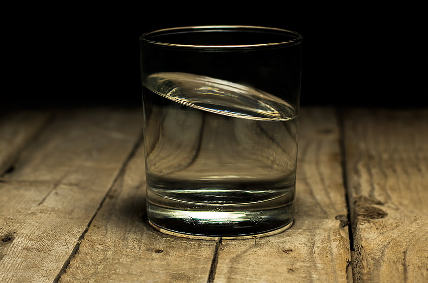 Glass of water on rustic wooden table