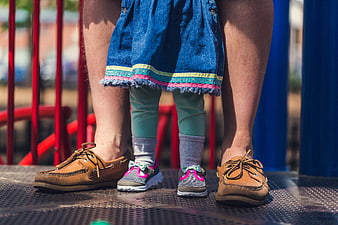 Close-up of Parent and Child Feet on Playground Equipment
