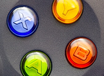 Close-up of colorful game controller buttons on dark background