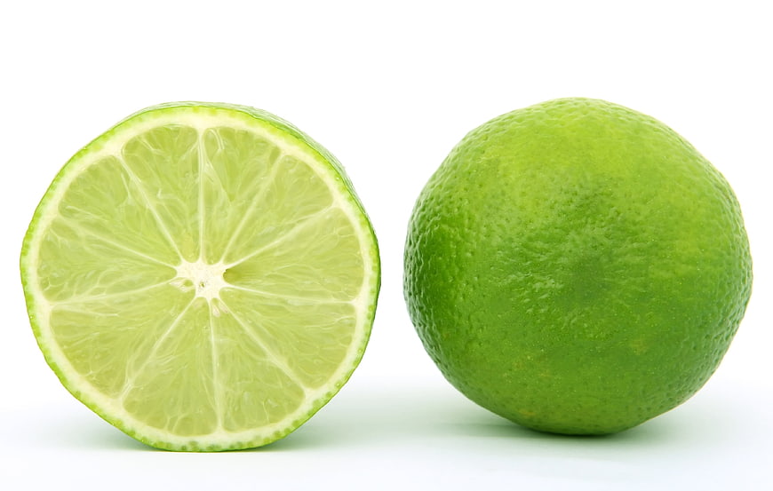 Fresh Green Lime Whole and Sliced on White Background