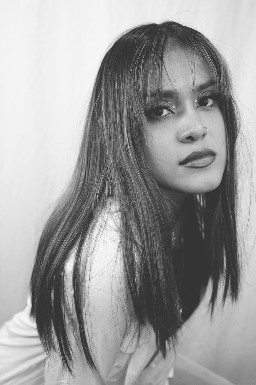 Black and white portrait of young woman with piercings