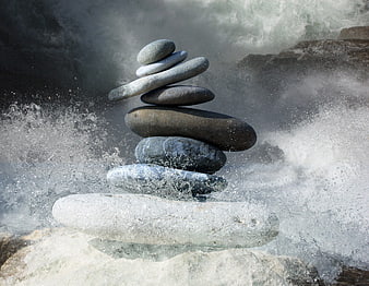 Stacked Zen Stones Balanced Amidst Splashing Ocean Waves