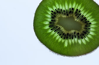 Macro Close-Up of Sliced Kiwi Fruit on White Background