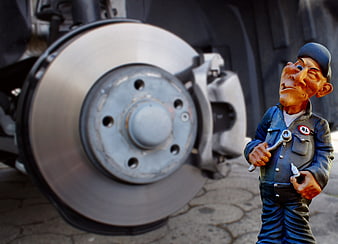 Mechanic figurine inspecting car brake disc and caliper